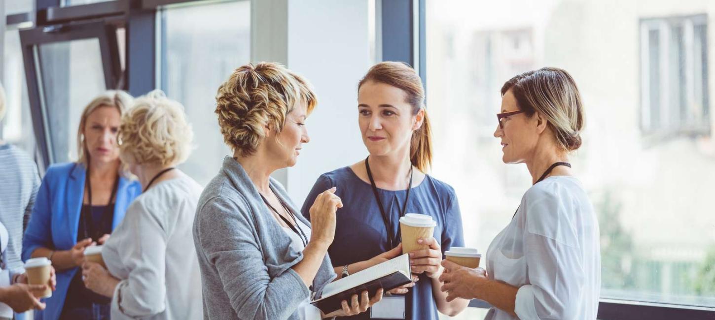 Group of women talking during coffee break at convention center. Break during a women seminar.